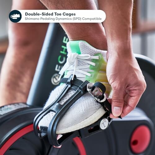 Person securing shoe in double-sided toe cage on exercise bike.